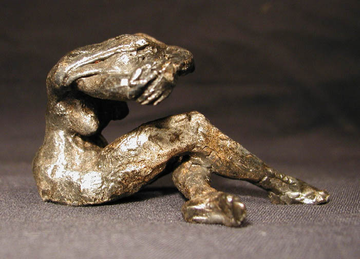 female_solemn_seatedhead_in_arms_rightb.jpg (67320 bytes)
